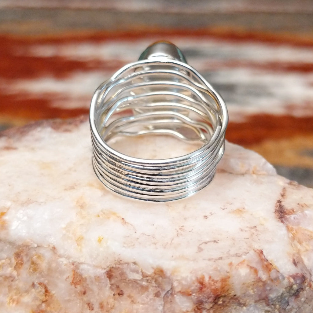 Close-up of the layered, wire band of the ring.