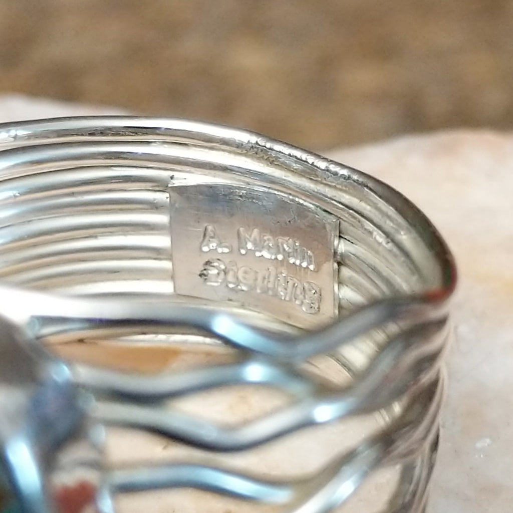 Close-up of the artisan's stamped signature.