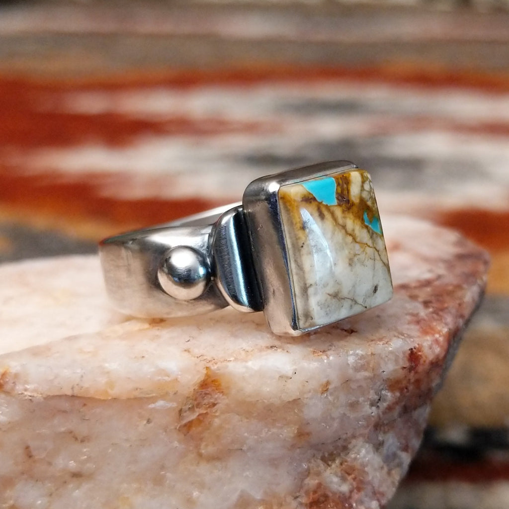 Square sterling silver bezel of the ring with boulder turquoise.