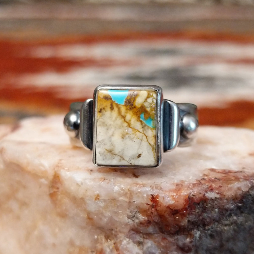 Square sterling silver bezel of the ring with boulder turquoise.