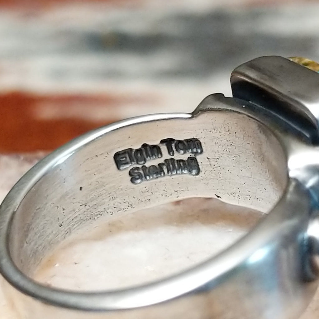 Close-up of the artisan's signature on the interior of the band.