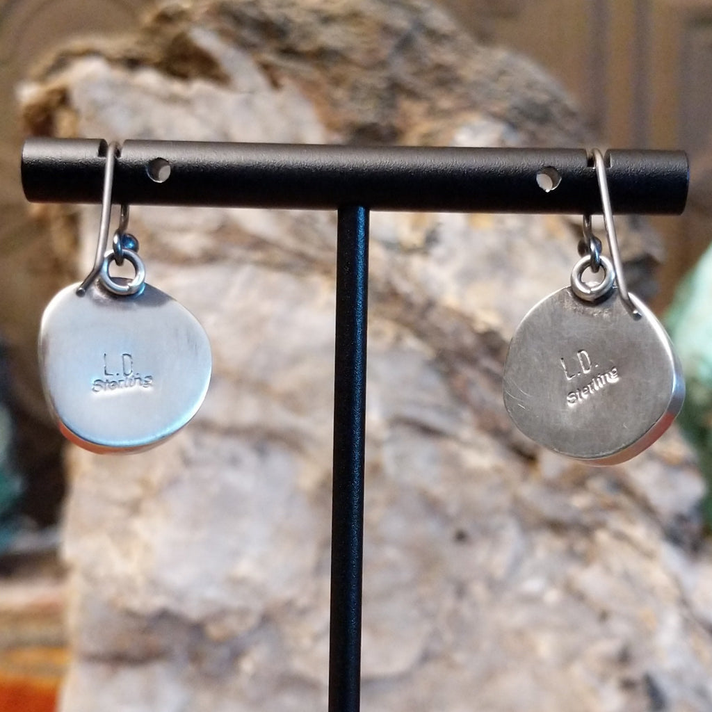 The back features the artisan's stamped signature.