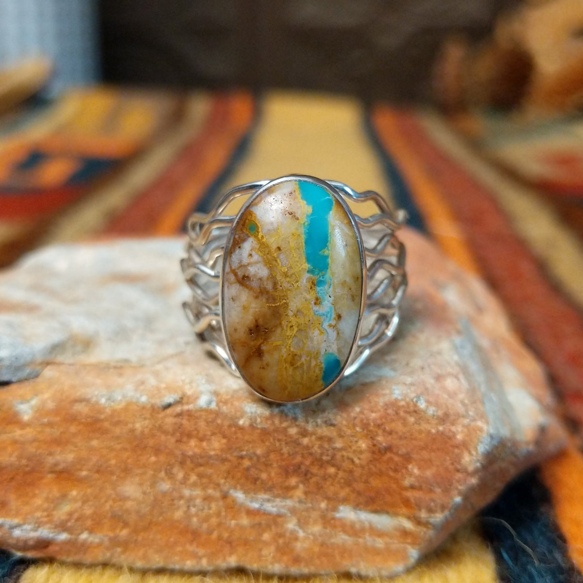 Boulder Turquoise Strand Ring by Angela Martin featuring a natural turquoise stone set in sterling silver, size 8, approximately 0.75 inches long and 0.875 inches wide. Handcrafted jewelry piece with distinctive turquoise patterns.