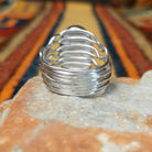 Boulder Turquoise Strand Ring by Angela Martin featuring a natural turquoise stone set in sterling silver, size 8, approximately 0.75 inches long and 0.875 inches wide. Handcrafted jewelry piece with distinctive turquoise patterns; underside view.