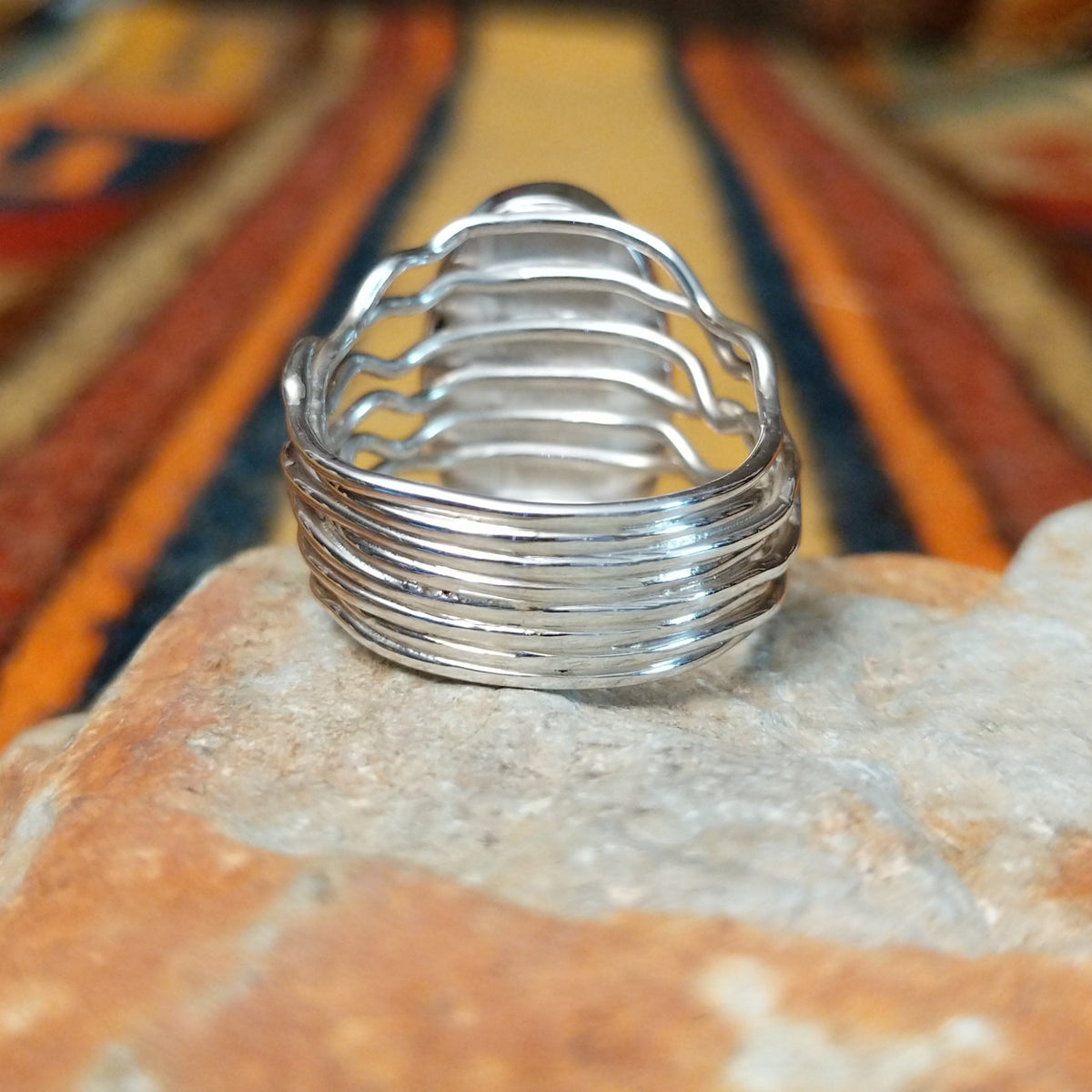 Boulder Turquoise Strand Ring by Angela Martin featuring a natural turquoise stone set in sterling silver, size 8, approximately 0.75 inches long and 0.875 inches wide. Handcrafted jewelry piece with distinctive turquoise patterns; underside view.