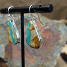 Handcrafted sterling silver Boulder Turquoise teardrop earrings by Lowell Draper, featuring natural Boulder Turquoise gemstones with vibrant blue and earthy matrix; side view.