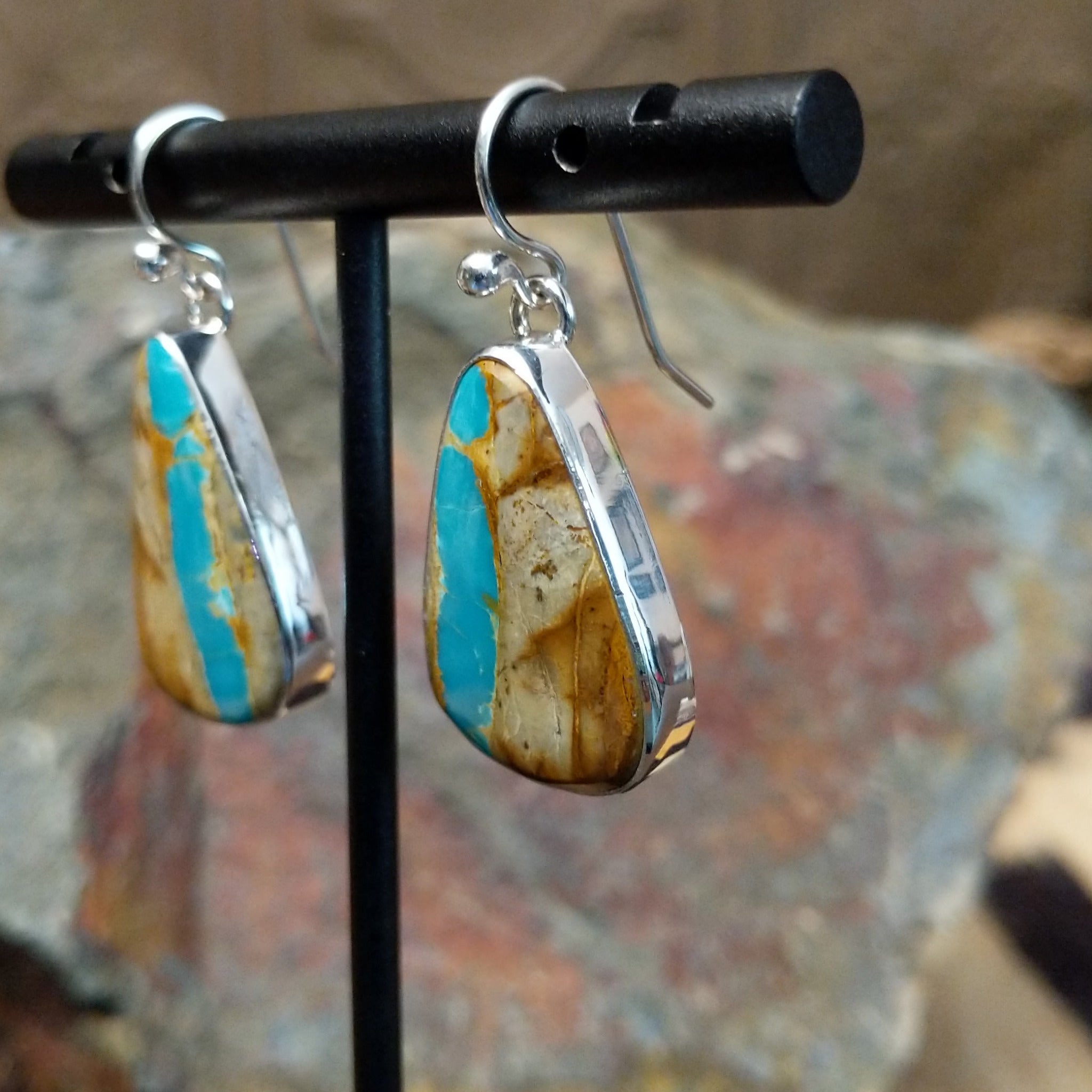 Handcrafted sterling silver Boulder Turquoise teardrop earrings by Lowell Draper, featuring natural Boulder Turquoise gemstones with vibrant blue and earthy matrix; side view.