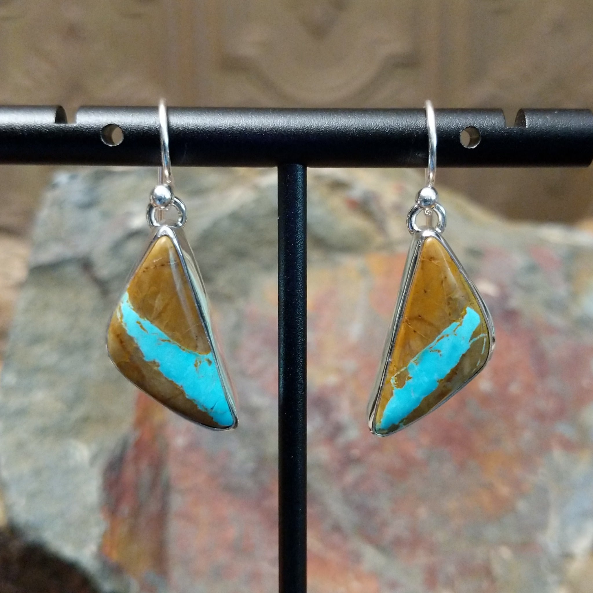Handcrafted sterling silver Boulder Turquoise triangle earrings by Lowell Draper, featuring natural Boulder Turquoise gemstones in classic bezel settings.