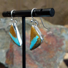 Handcrafted sterling silver Boulder Turquoise triangle earrings by Lowell Draper, featuring natural Boulder Turquoise gemstones in classic bezel settings; side view.