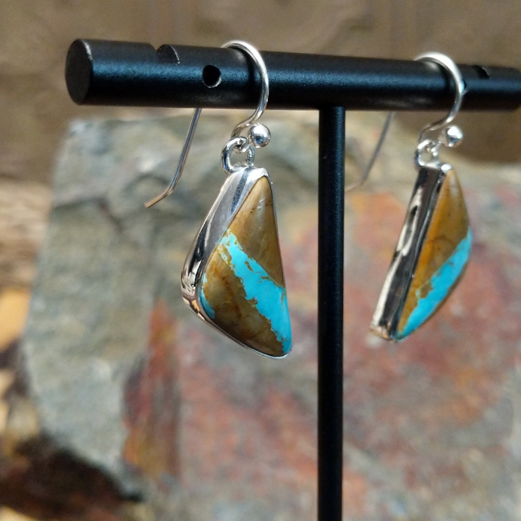 Handcrafted sterling silver Boulder Turquoise triangle earrings by Lowell Draper, featuring natural Boulder Turquoise gemstones in classic bezel settings; side view.
