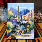 Boulders 2 canvas artwork by Diana Madaras featuring towering saguaro cacti, colorful desert boulders, distant mountains, and vibrant Southwestern vegetation in shades of blue, purple, green, and yellow.
