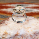 Sterling silver ring with sonoran gold turquoise framed by twisted rope accents and ornate details.