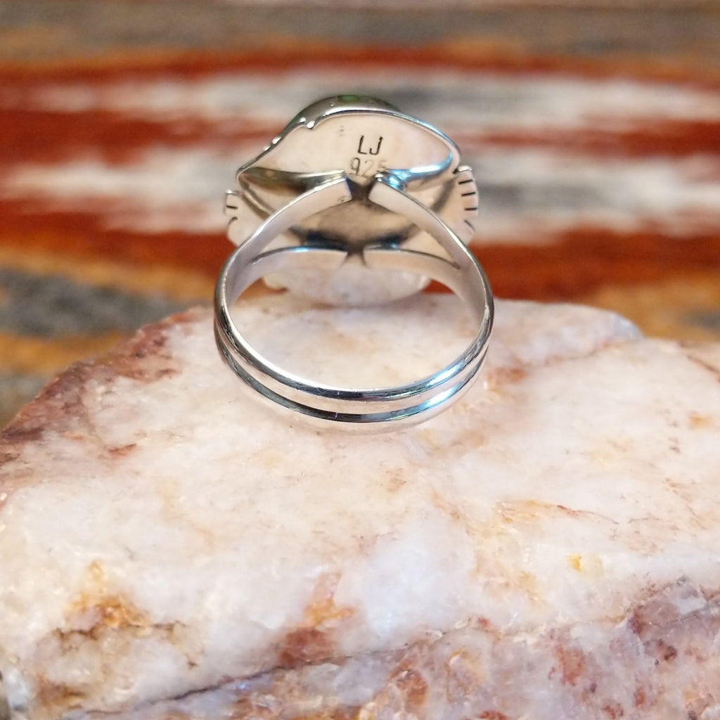 Sterling silver ring with sonoran gold turquoise framed by twisted rope accents and ornate details.