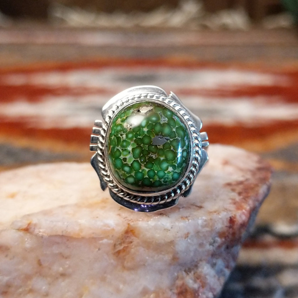 Sterling silver ring with sonoran gold turquoise framed by twisted rope accents and ornate details.