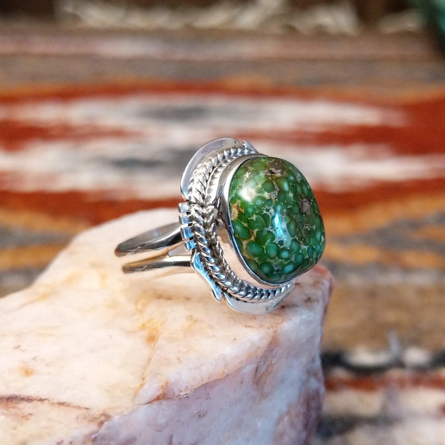 Sterling silver ring with sonoran gold turquoise framed by twisted rope accents and ornate details.