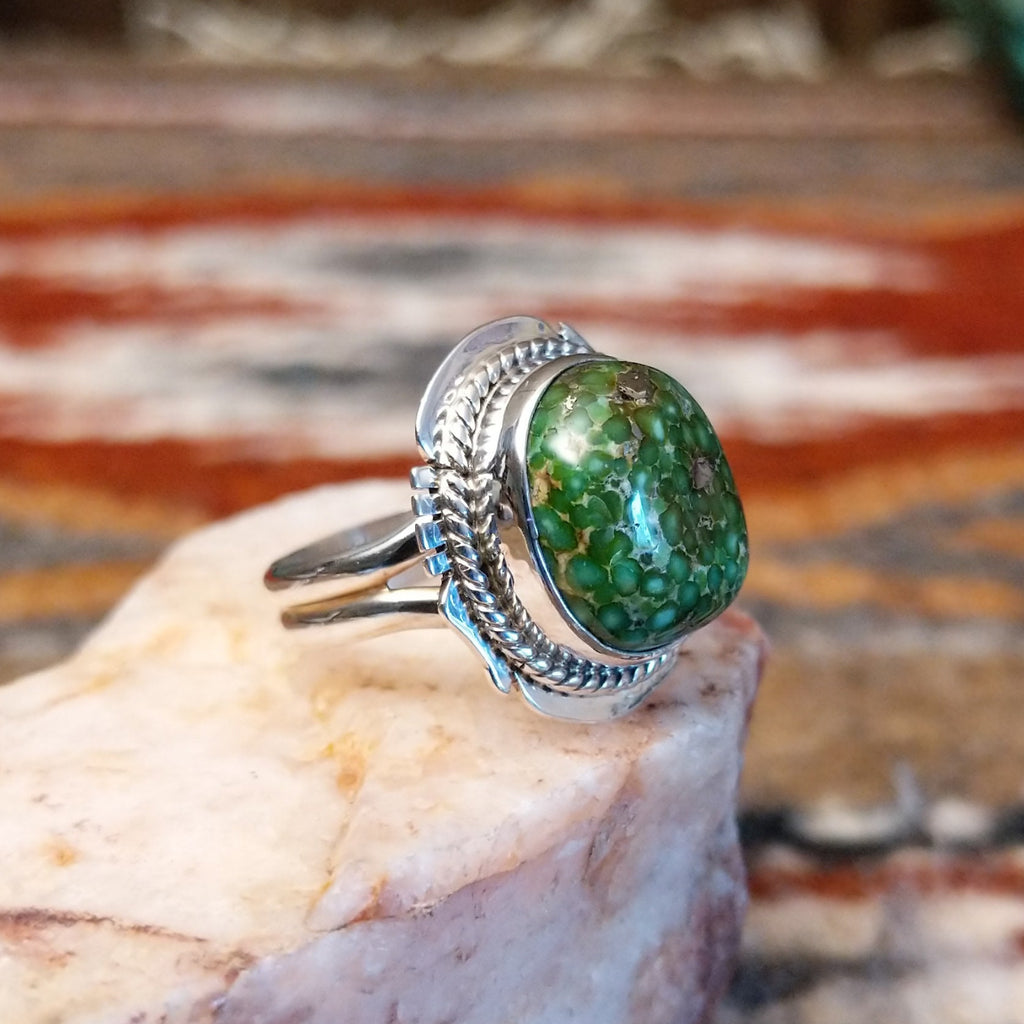 Sterling silver ring with sonoran gold turquoise framed by twisted rope accents and ornate details.