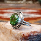 Sterling silver ring with sonoran gold turquoise framed by twisted rope accents and ornate details.