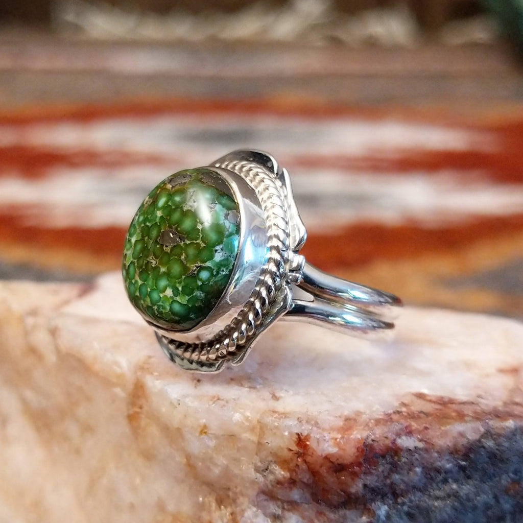 Sterling silver ring with sonoran gold turquoise framed by twisted rope accents and ornate details.