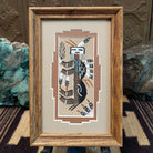 Framed Navajo sand painting of a stylized buffalo with feather motifs.