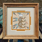 Framed Navajo sand painting of a stylized buffalo with feather and geometric motifs. 