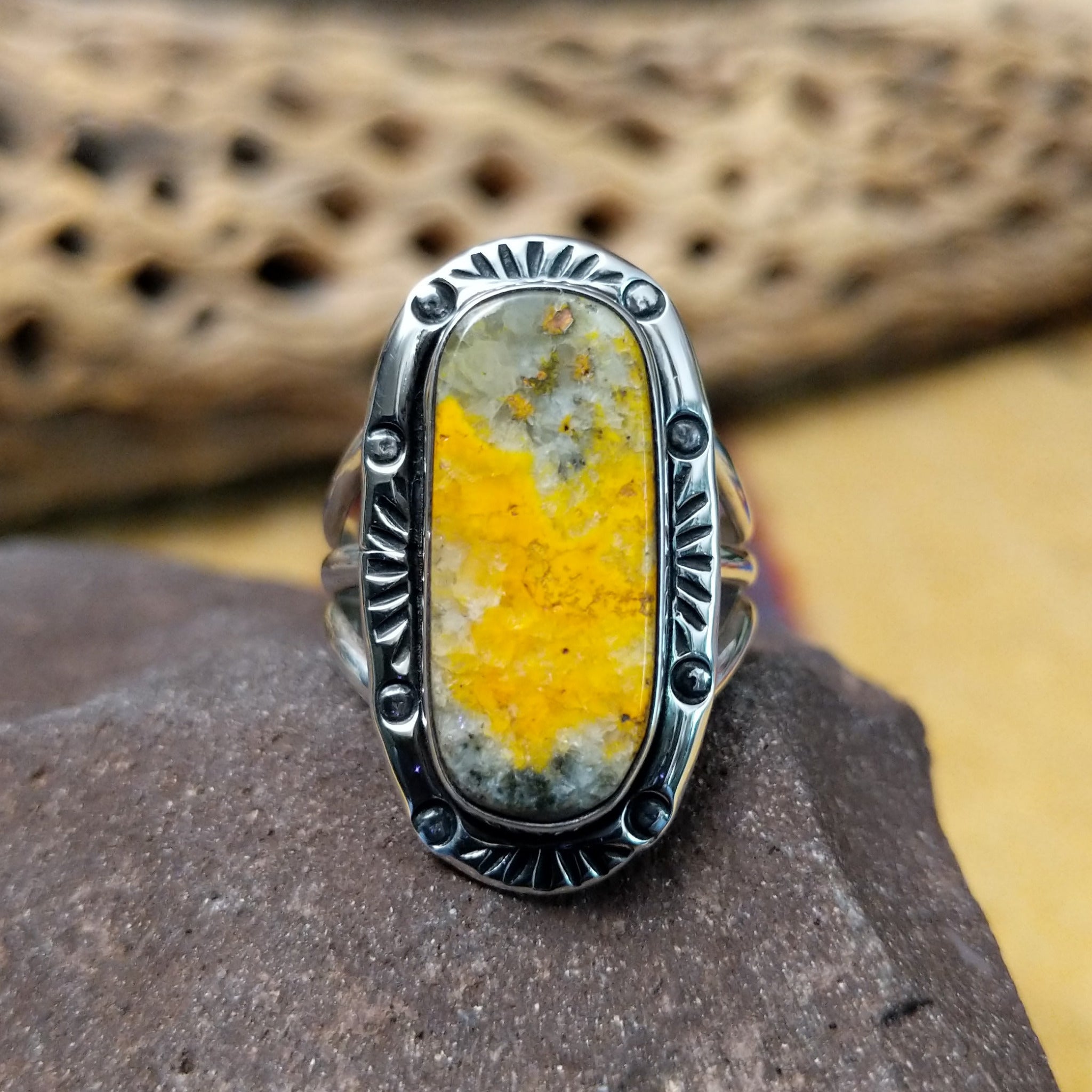 Bumblebee jasper capsule ring by Terry Wood, featuring a capsule-shaped bumblebee jasper stone with natural yellow, orange, black, and gray patterns set in a handcrafted sterling silver band.