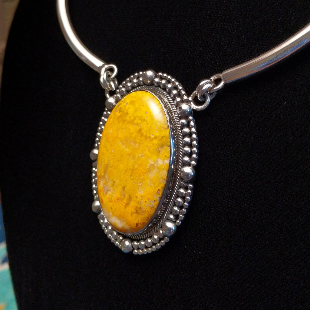 Bumblebee jasper stone set in a dotted bezel with a sterling silver linked collar.