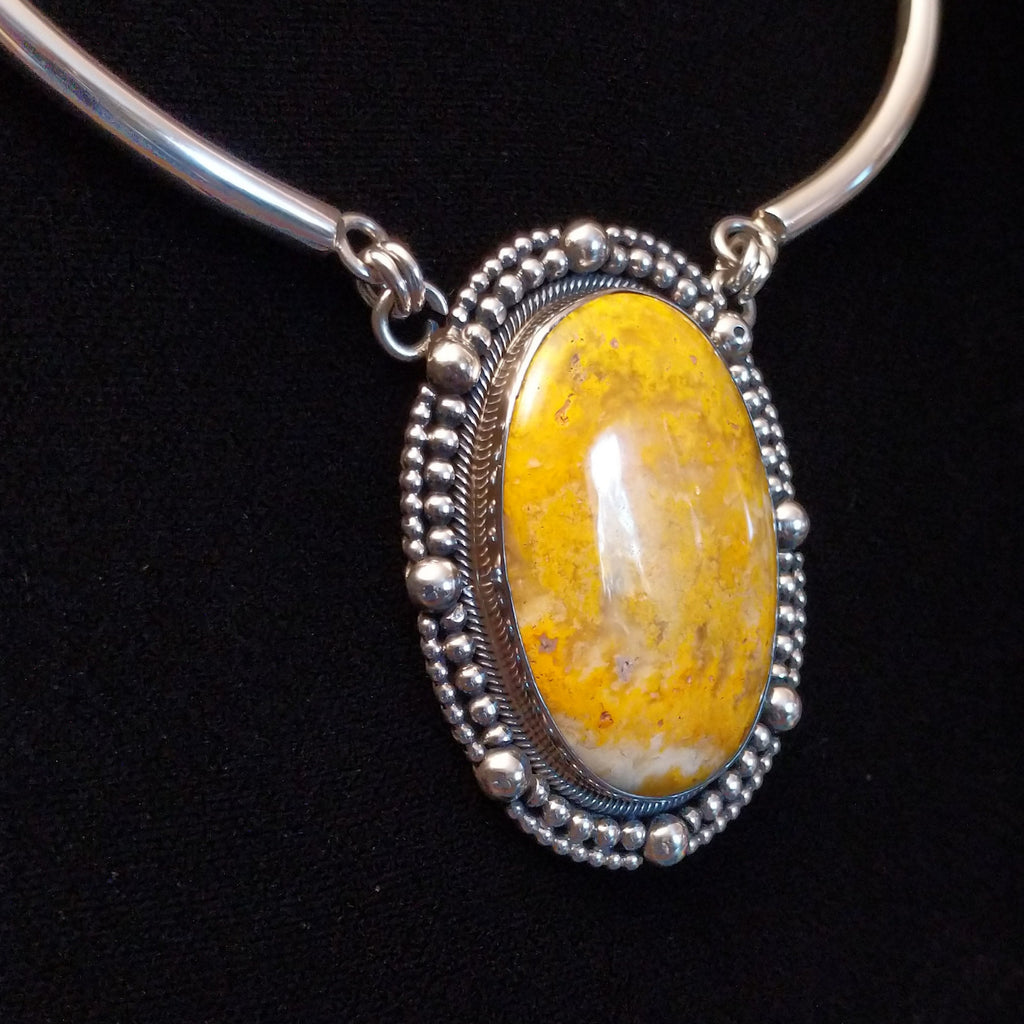 Bumblebee jasper stone set in a dotted bezel with a sterling silver linked collar.