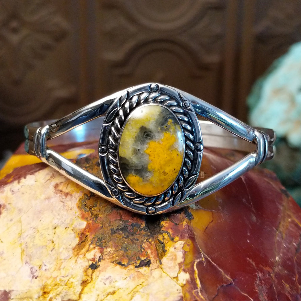 Bumblebee jasper set in a twisted rope bezel with sterling silver duel-layered band.