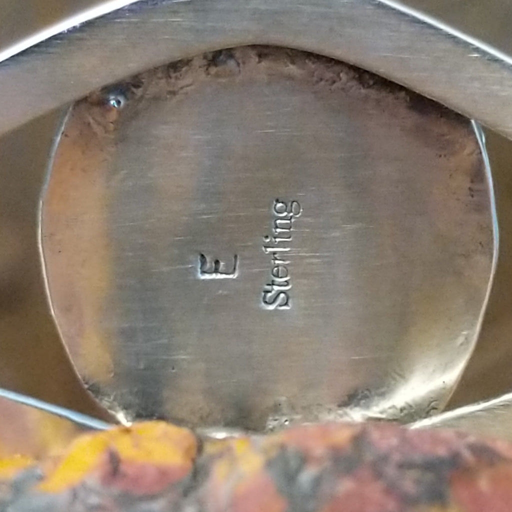 The artisan's stamped initial.