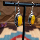 Sterling silver earrings with bumblebee jasper set in oval bezels, framed by incised lining.
