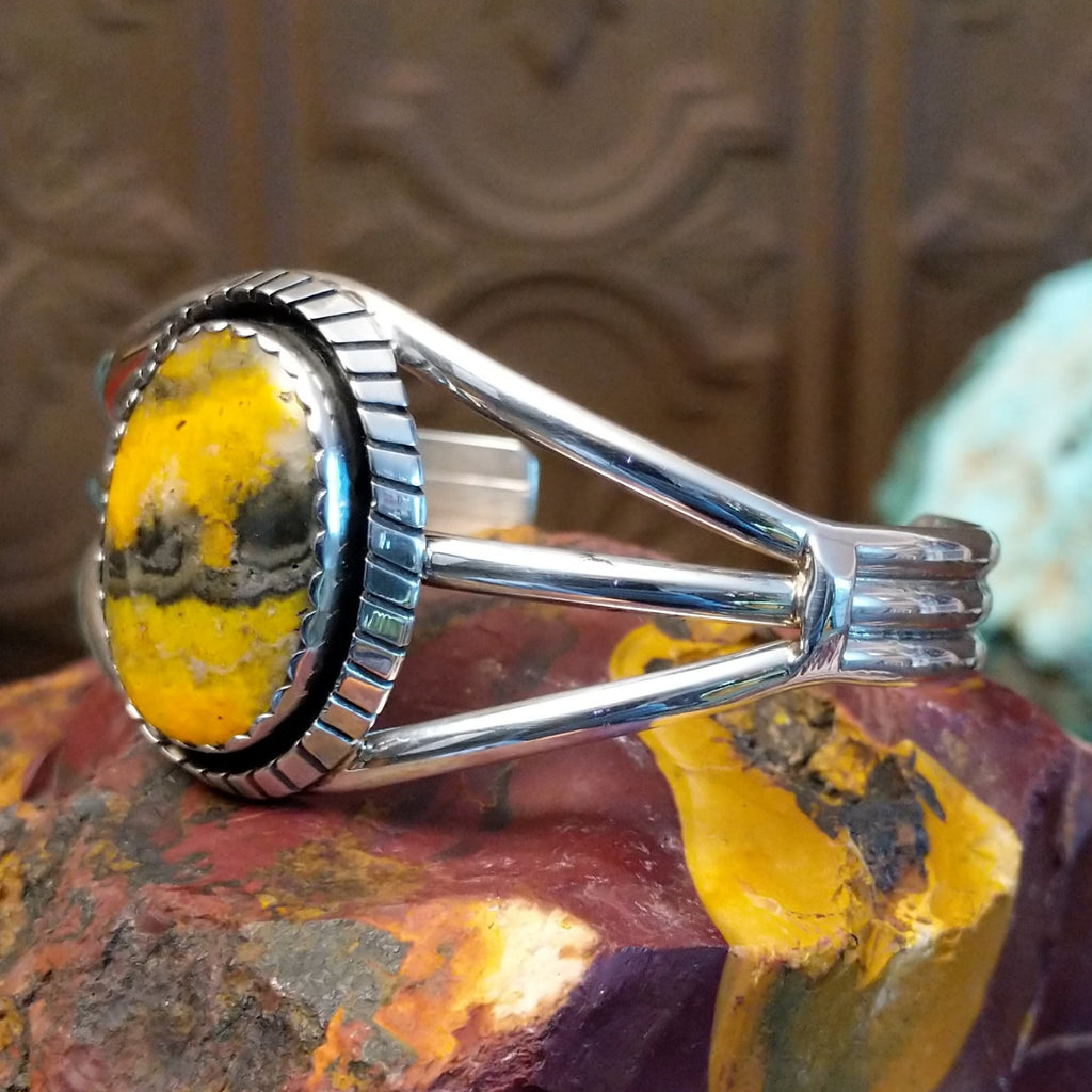 Bumblebee jasper set in a scalloped bezel with ridged frame and tri-layered band.