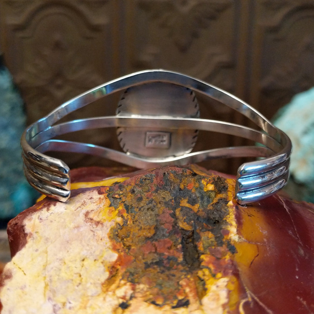 Bumblebee jasper set in a scalloped bezel with ridged frame and tri-layered band.