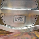 The back features the artisan's stamp.