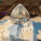Sterling silver ring with bumblebee jasper set in an oval bezel and ornate stamping on the band.