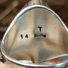 Close-up of the artisan's stamped signature.