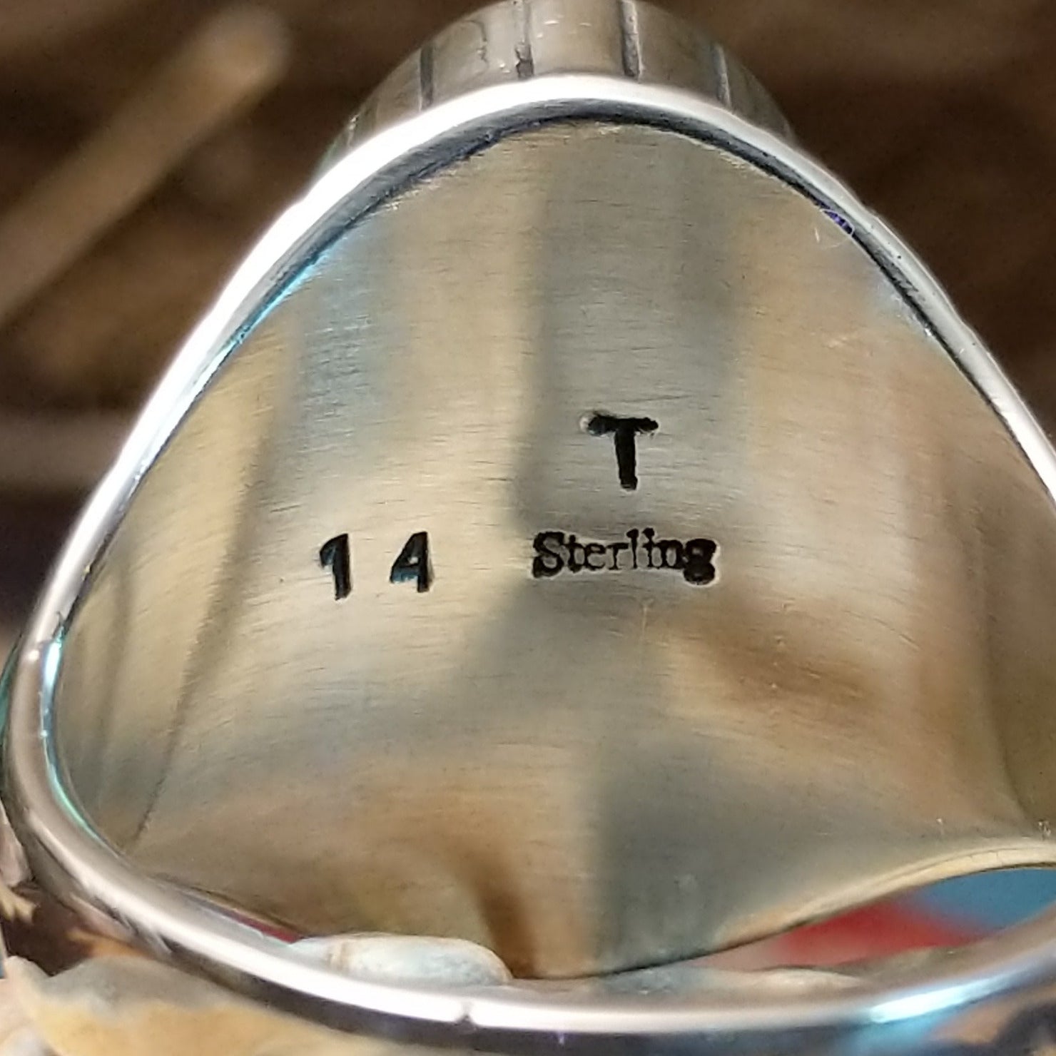 Close-up of the artisan's stamped signature.