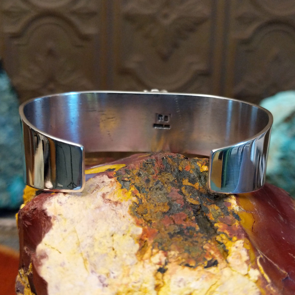 Teardrop shaped bumblebee jasper framed by dotted accents on a polished sterling silver band.