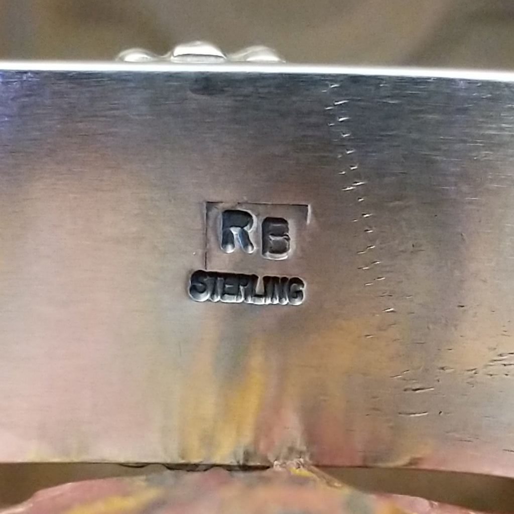 Close-up of the artisan's stamped signature.