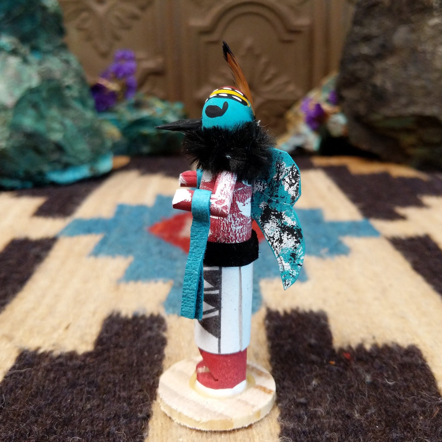 Mini butterfly kachina by Rosalind Grey with turquoise face, black fur collar, feathered crest, and white geometric-patterned garment.