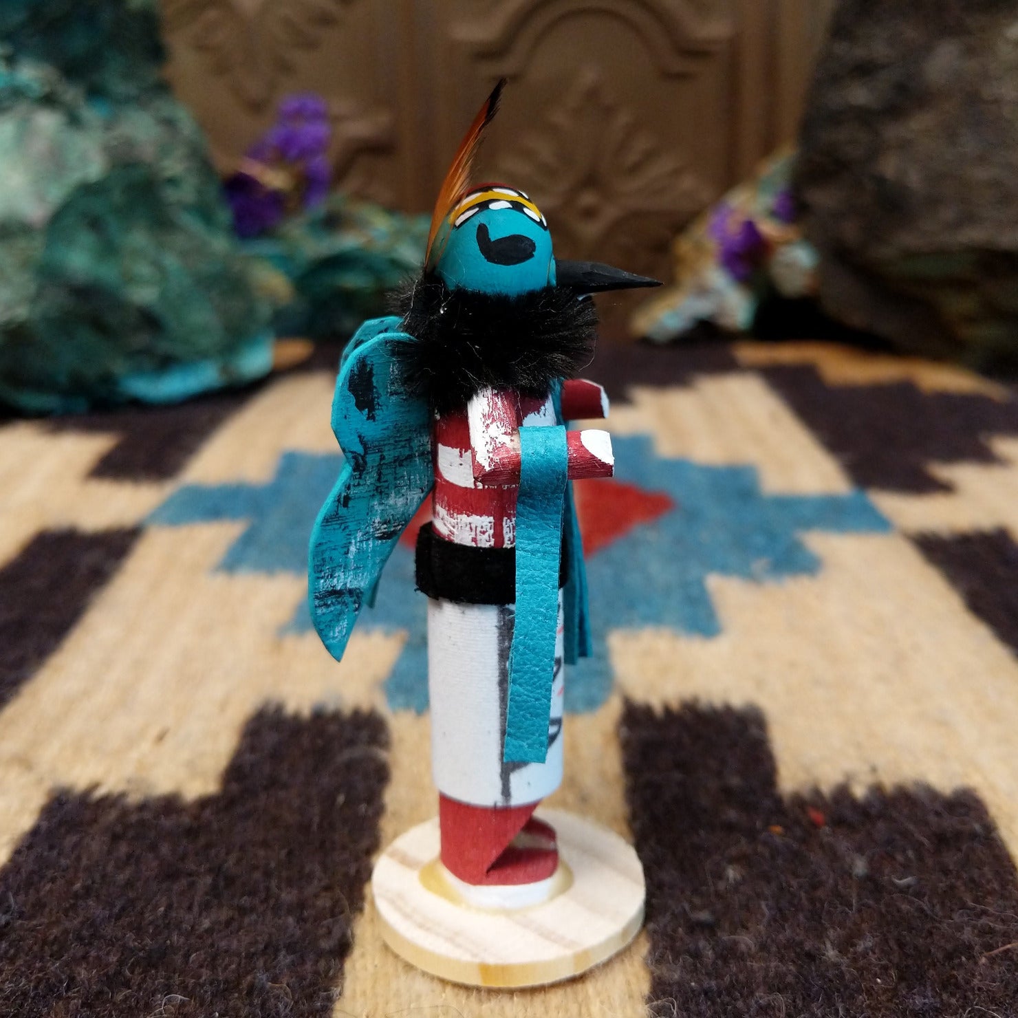 Mini butterfly kachina by Rosalind Grey with turquoise face, black fur collar, feathered crest, and white geometric-patterned garment.