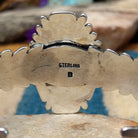 Handcrafted sterling silver shield cuff by Benjamin Piaso featuring an oval Carico Lake turquoise cabochon with ornate silver beadwork, scroll accents, blossom details, and an openwork design; artisan and Sterling Silver stamp.