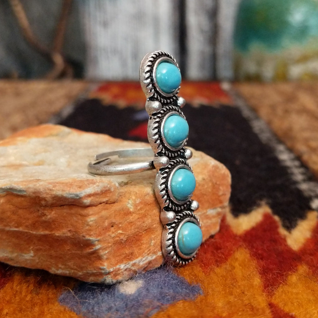 Nickel-free metal ring with four turquoise stones and twisted rope detailing.
