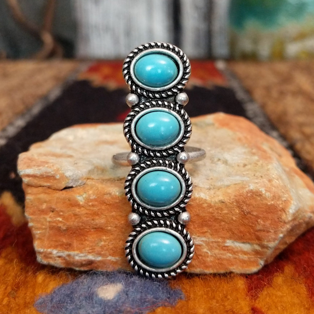 Nickel-free metal ring with four turquoise stones and twisted rope detailing.