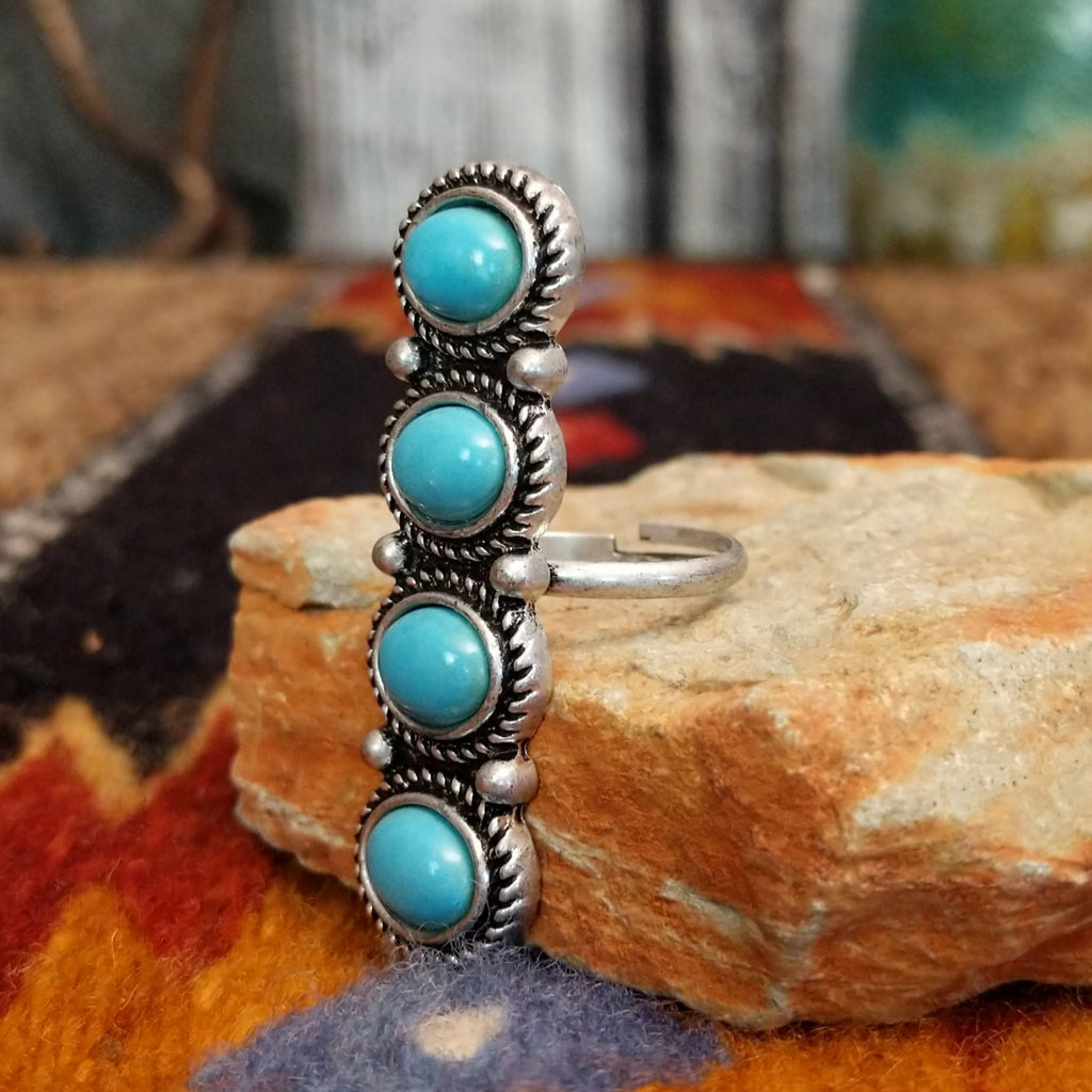 Nickel-free metal ring with four turquoise stones and twisted rope detailing.