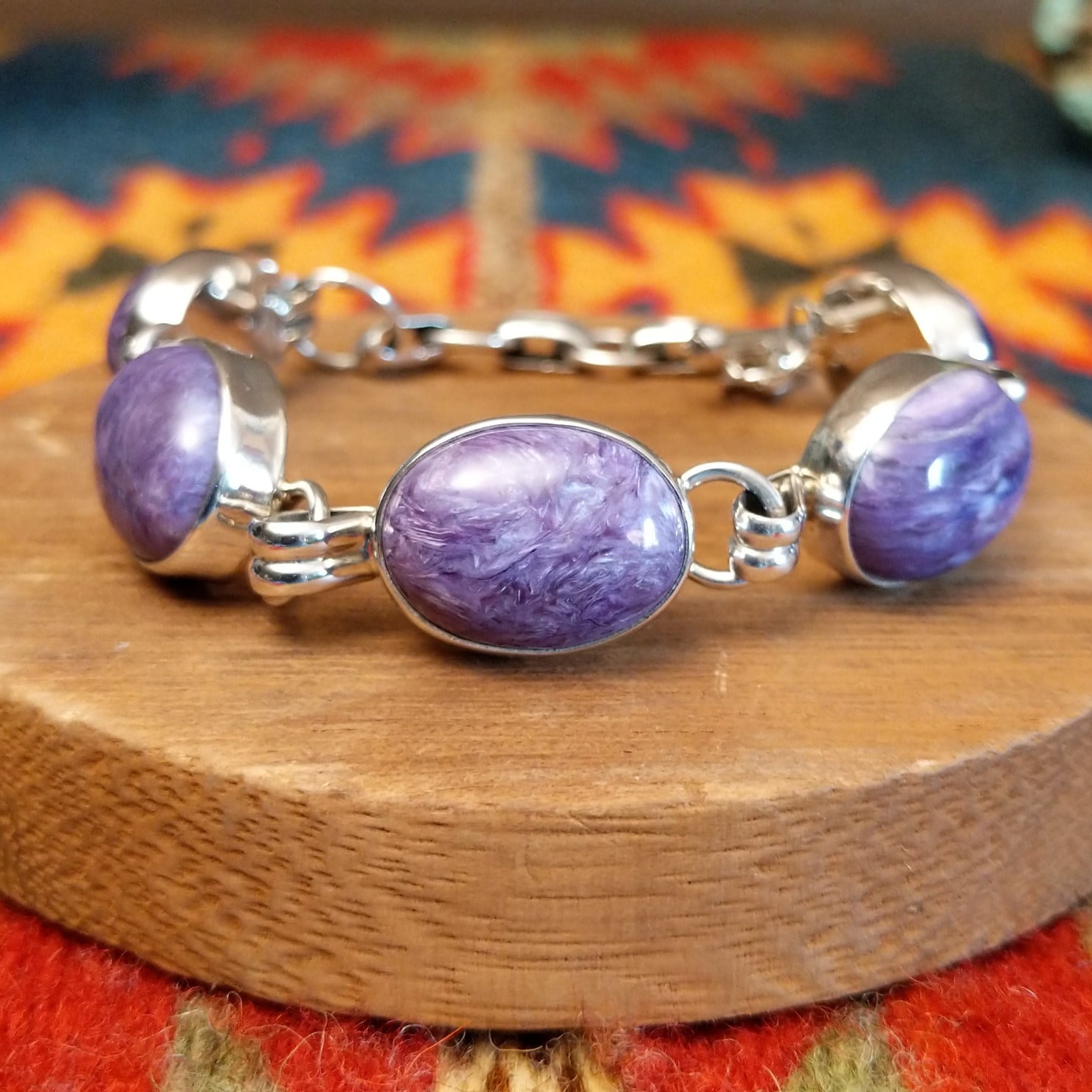 Sterling silver link bracelet with charoite set in oval bezels.