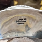 Close up of the artist's stamped signature.