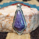 Sterling silver pendant with charoite set in a shield-shaped bezel, framed by twisted rope and dotted accents.