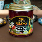 Jar of Cheri’s Desert Harvest Prickly Pear Cactus Jelly featuring a bright pink-purple color. Artisanal fruit jelly made from prickly pear cactus, ideal for spreading on baked goods or pairing with cheese.