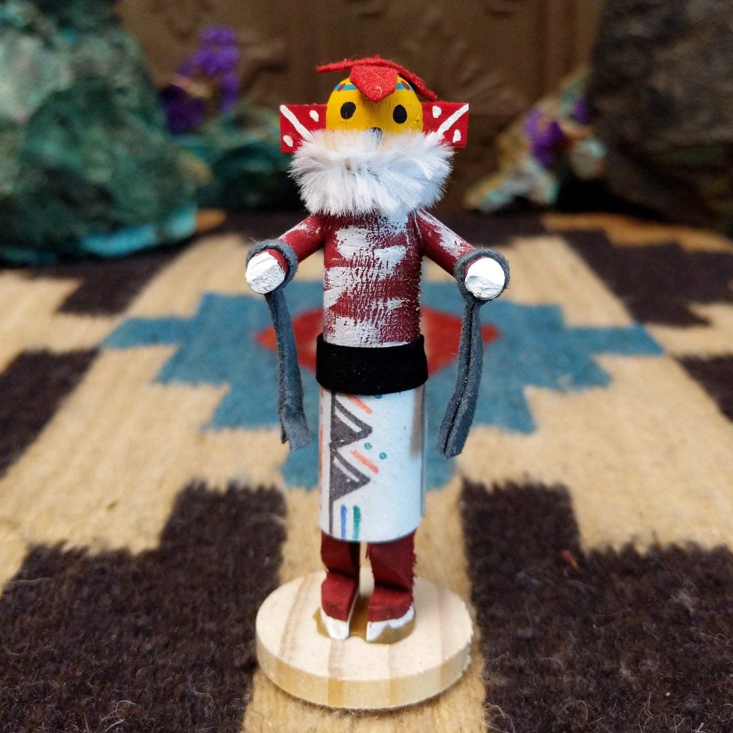 Mini chili pepper kachina by Rosalind Grey with yellow face, white fur collar, red body, and white geometric-patterned garment.