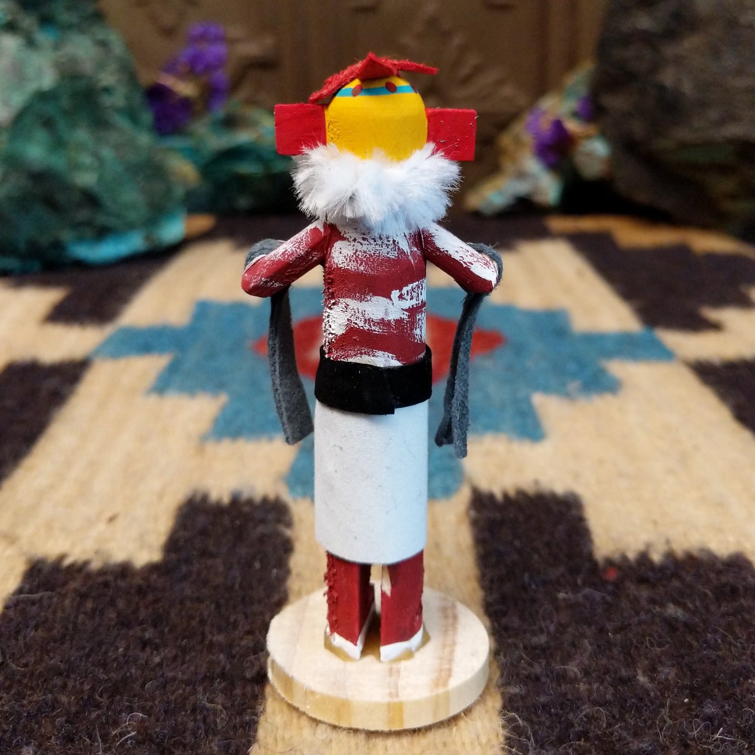 Mini chili pepper kachina by Rosalind Grey with yellow face, white fur collar, red body, and white geometric-patterned garment.